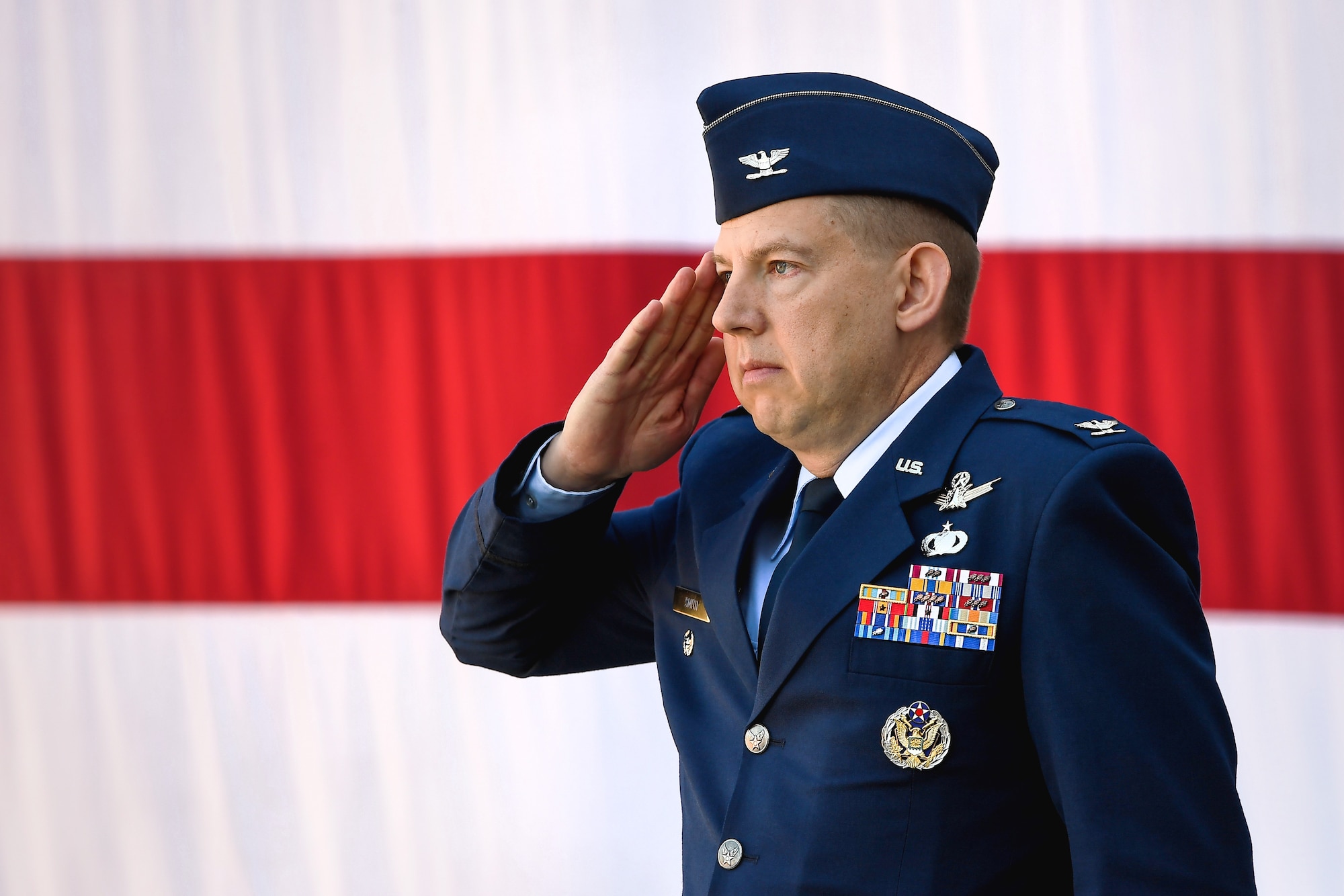 Col. James Smith, 50th Space Wing commander, renders his first salute as commander of the wing during a change of command ceremony in front of the DeKok building at Schriever Air Force Base, Colorado, June 24, 2019. The 50th SW is responsible for 185 communications, navigation and surveillance satellites and is geographically spread across the world in 14 operating locations. (U.S. Air Force photo by Kathryn Calvert)