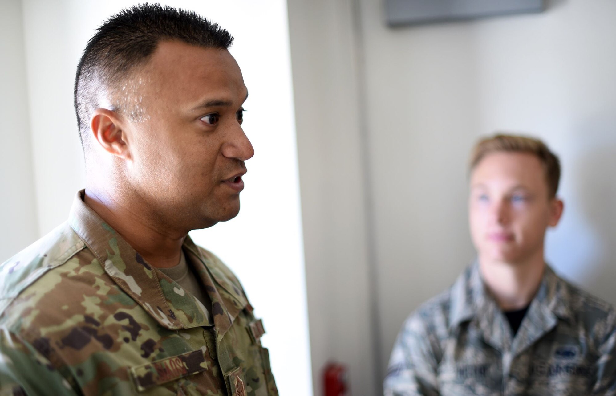 U.S. Air Force Master Sgt. Stanley Siaosi, 60th Operations Support Squadron chief controller, left, briefs control tower protocol to participants of an Airman enrichment day including Airman 1st Class Caden Victor, 860th Aircraft Maintenance Squadron aircraft maintainer, right, June 14, 2019, at Travis Air Force Base, California. The Airman enrichment day was the first of its kind in the Air Force and exposed Airmen of different Travis units to the jobs and mission contributions of other Air Force jobs. (U.S. Air Force photo by Senior Airman Christian Conrad)