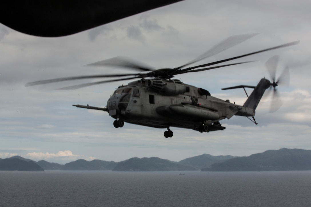 U.S. Marines with Marine Heavy Helicopter Squadron 462 conduct preflight inspections on a CH-53E Super Stallion June 07, 2019 at Marine Corps Air Station Futenma, Okinawa, Japan. HMH-462 flew from Marine Corps Air Station Futenma to Marine Corps Air Station Iwakuni to conduct training that enhances the squadron’s readiness and capabilities in providing aerial refueling and assault support, demonstrating the operational flexibility and tactical supremacy this platform brings to the Indo-Pacific region. (U.S. Marine Corps photo by Lance Cpl. Leo Amaro)