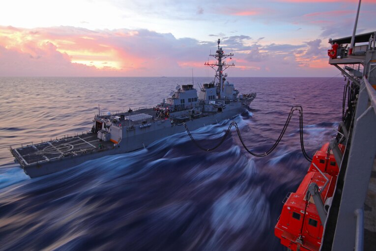 A ship connects to another via a fuel line.