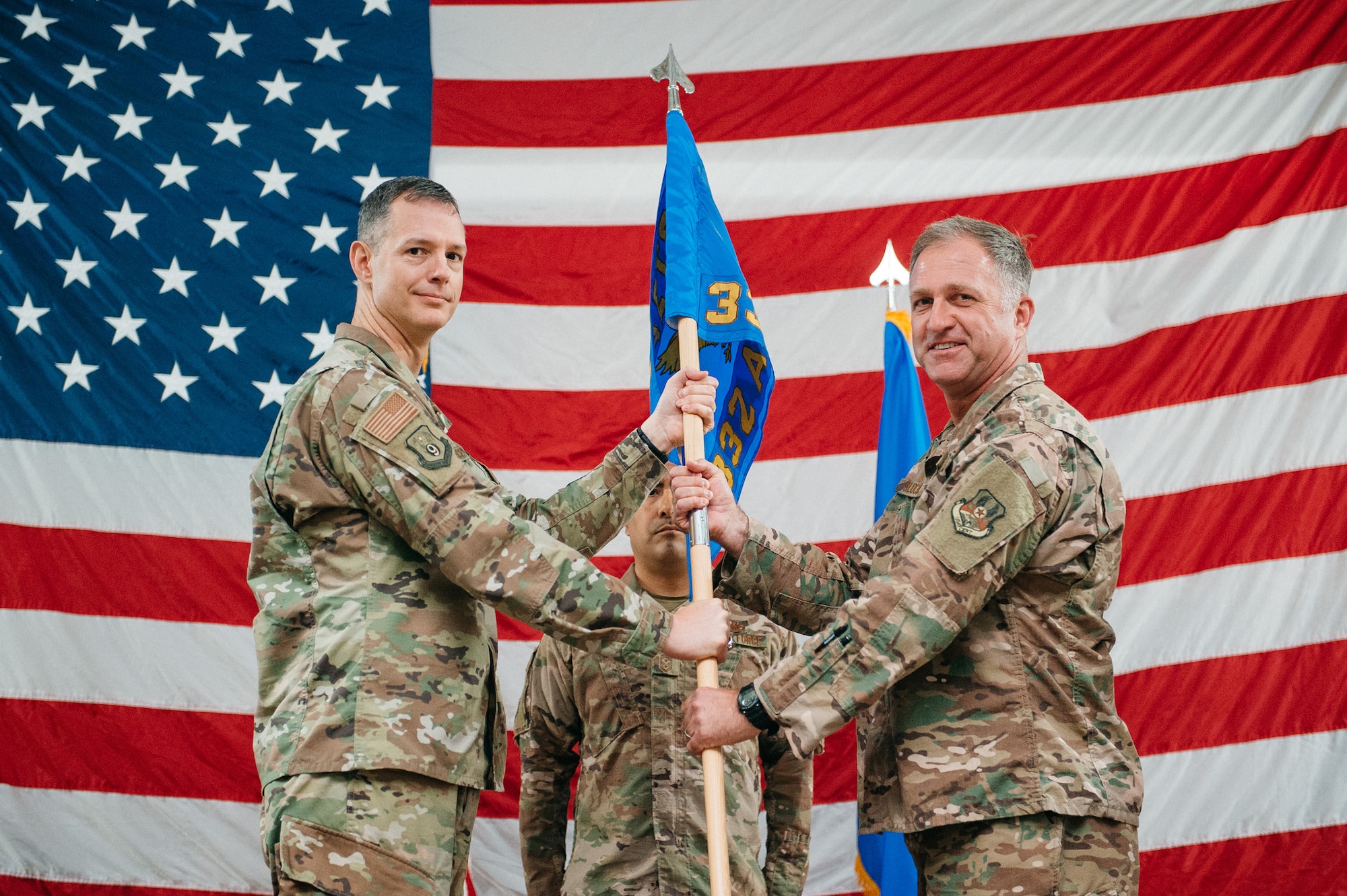 Brig. Gen. Mark Slocum, right, accepts command of the 332nd Air Expeditionary Wing from Maj. Gen. Alexus Grynkewich, 9th Air Expeditionary Task Force-Levant commander, during a change of command ceremony in Southwest Asia, June 20, 2019.