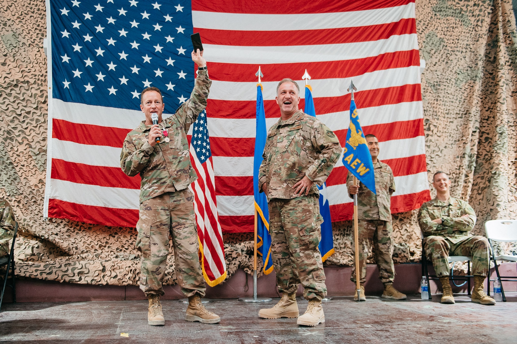 Brig. Gen. Mark Slocum, right, speaks with his predecessor Brig. Gen. David Iverson during a change of command ceremony in Southwest Asia, June 20, 2019.