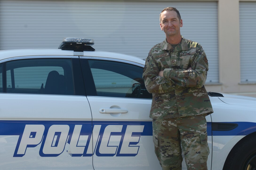 U.S. Air Force Master Sgt. Jeremy Schoneboom, first sergeant of the 31st Security Forces Squadron poses for a photo next to a vehicle at Aviano Air Base, Italy, June 26, 2019. The 31st Security Forces Squadron maintains installation force protection during peacetime and wartime operations within eight separate base areas. (U.S. Air Force photo by Airman 1st Class Ericka A. Woolever).
