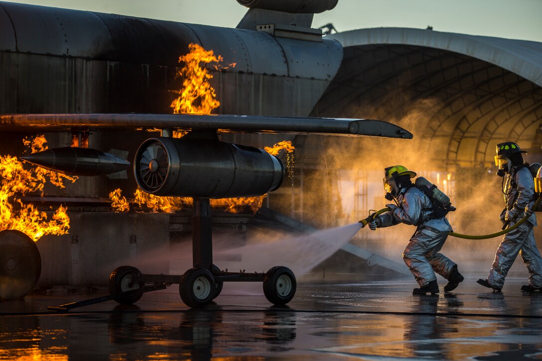 U.S. Marines with Aircraft Rescue and Firefighting, Headquarters and Headquarters Squadron (H&HS), Marine Corps Air Station Yuma conduct hand line drills during live burn training on MCAS Yuma, Arizona, June 25, 2019. Hand line drills focus on techniques to push fuel fires away from aircraft, ARFF Marines train monthly to enhance their readiness when responding to emergencies on the flight line.
