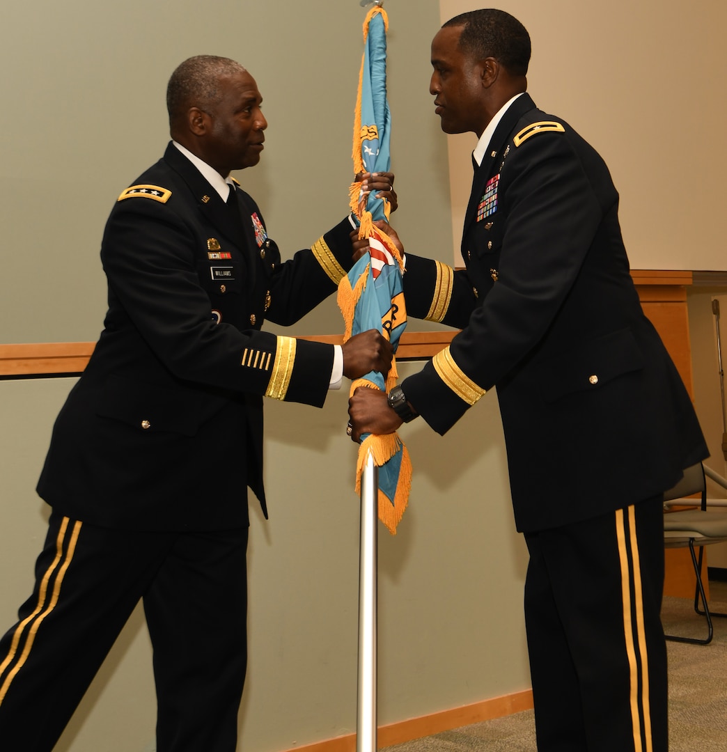 DLA Director Army Lt. Gen. Darrell Williams, left, passes the DLA Troop Support flag to Brig. Gen. Gavin Lawrence who assumed command of the organization at a ceremony June 25, 2019 in Philadelphia.