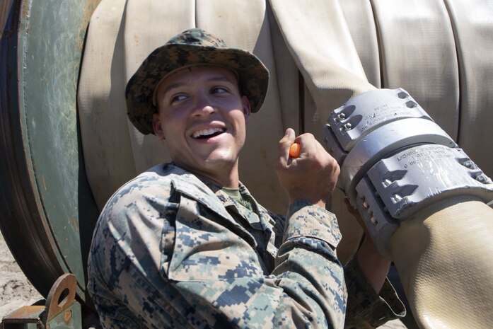U.S. Marine Corps Cpl. Shane Pizzuto with Bulk Fuel Company, 8th Engineer Support Battalion (ESB), 2nd Marine Logistics Group, unscrews a bolt on a fuel hose clamp during a Bulk Fuel exercise at Camp Lejeune, North Carolina, June 19, 2019 The Marines with 8th ESB ran fuel lines, patrolled the fuel sites and provided all around security to remain proficient in fueling support operations. (U.S. Marine Corps photo by Lance Cpl. Adaezia L. Chavez)