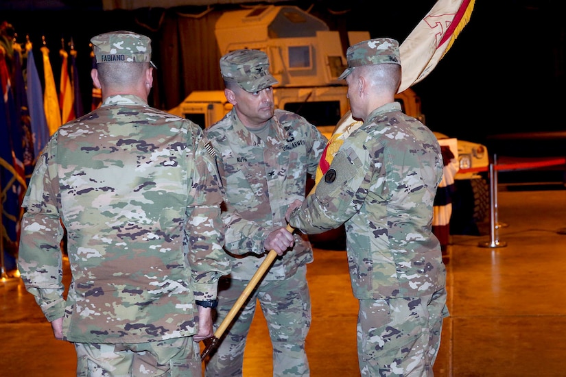 Col. Robert Kuth passes the Area Support Group-Qatar's flag to U.S. Army Central's Deputy Commanding General, Maj. Gen. David Hill, during the brigade change of command ceremony at Camp As Sayliyah, Qatar June 24, 2019. Kuth has been ASG-Qatar's commander for 26 months. More than 160 service members attended the ceremony.