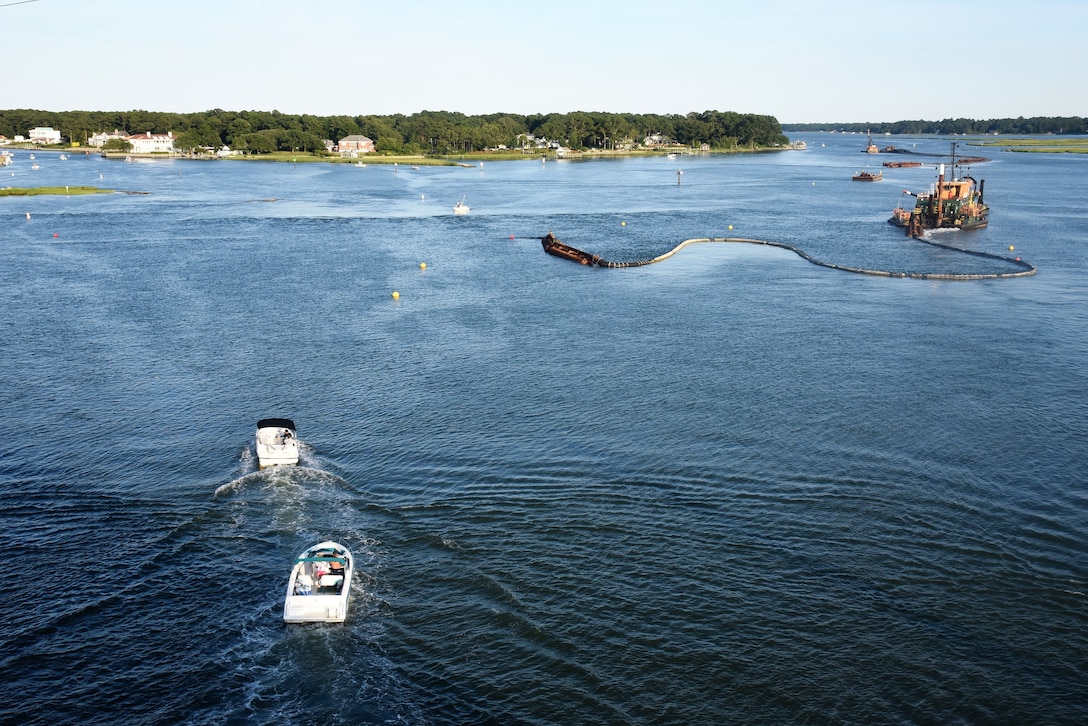 A dredge pipeline floats out before submerging behind the hydraulic cutter head dredge, as it positions to begin a cut in the turning basin of the Lynnhaven Inlet Federal Navigation Project, Virginia Beach, Virginia.