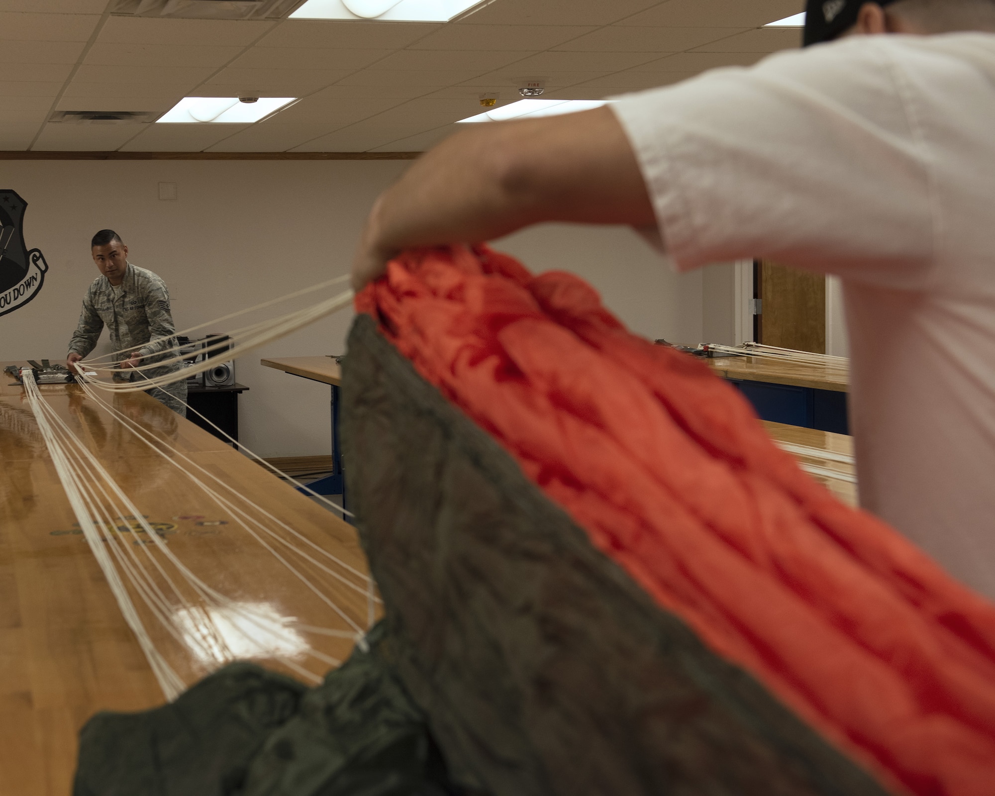 Staff Sgt. Kenny Batallas, 56th Operations Support Squadron Aircrew Flight Equipment maintenance section noncommissioned officer in charge, checks a parachute’s line continuity June 20, 2019, at Luke Air Force Base, Ariz.