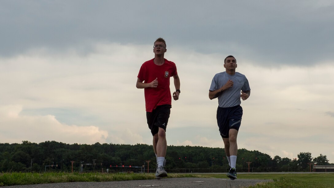 Left, U.S. Air Force Airman 1st Class Joshua Truax, 633rd Communications Squadron client systems technician, and Airman Joshua Rissman, 633rd Communication Squadron cable and antenna systems technician, run at Joint Base Langley-Eustis, Virginia, June 18, 2019.