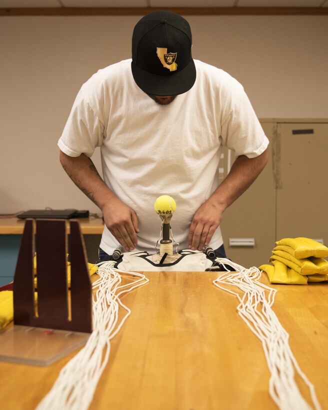 Juan Gonzalez, 56th Operations Support Squadron Aircrew Flight Equipment technician, packs a parachute June 20, 2019, at Luke Air Force Base, Ariz.