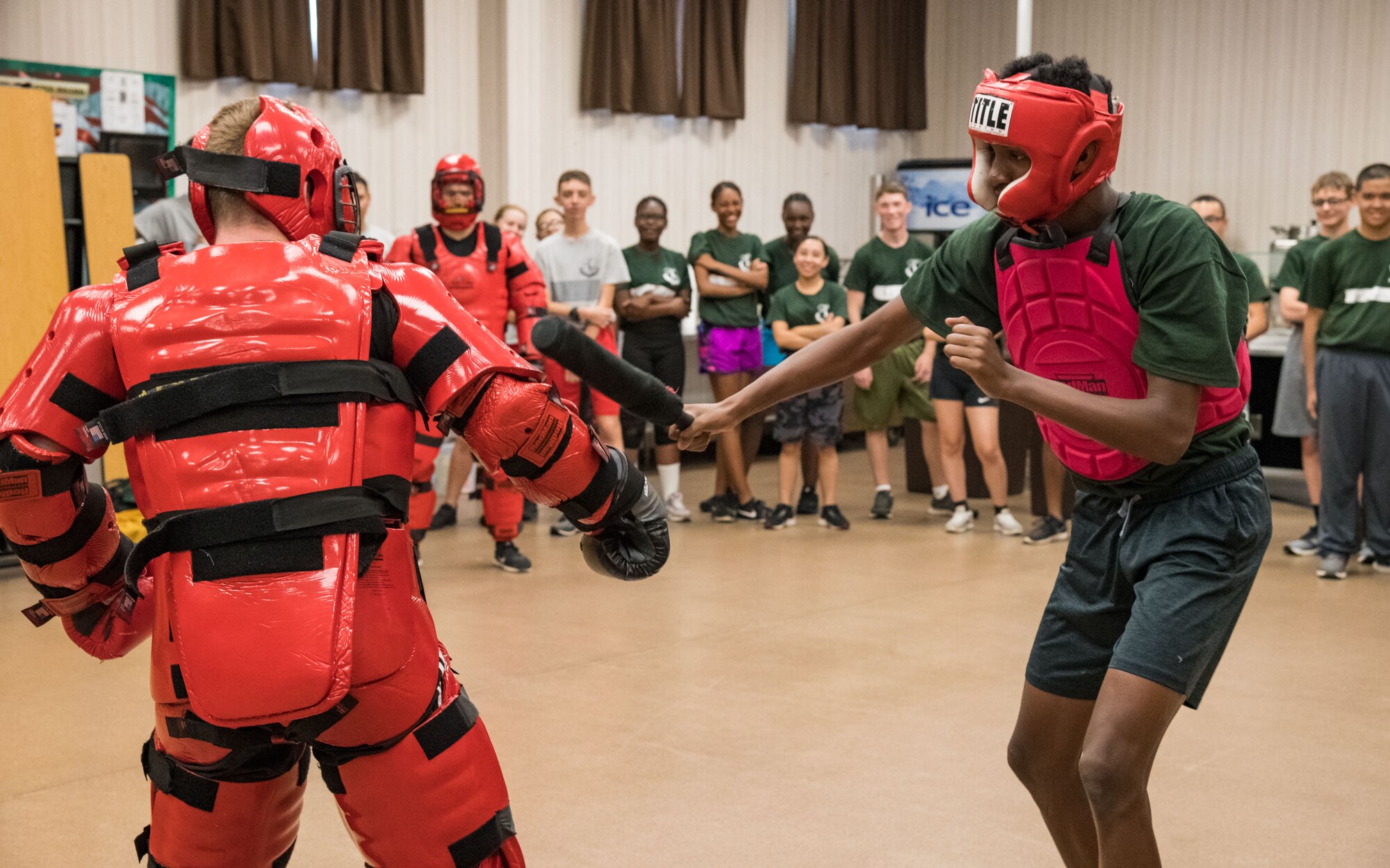 Air Force Junior Reserve Officers’ Training Corps cadet Jemiere Perry of Dragon Flight, uses a baton to hit “Redman” June 19, 2019, at the Delaware National Guard Bethany Beach Training Site, Bethany Beach, Del. Seven Ravens from the 436th Security Forces Squadron, Dover Air Force Base, Del., provided cadets the opportunity to fend off a Raven in a Redman training suit during the Cadet Leadership Course. (U.S. Air Force photo by Roland Balik)