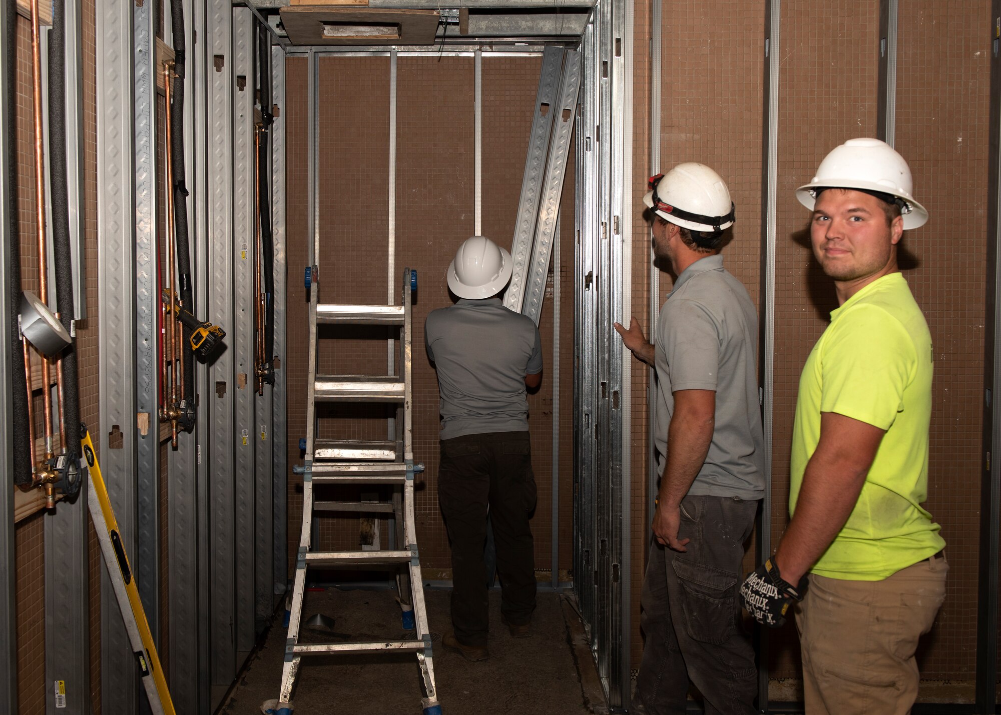 Contractors wih Expert Maintenance partnered with the U.S. Army Corps of Engineers work to replace ceiling framework on June 20, 2019, at Whiteman Air Force Base, Missouri. Renovations to the Whiteman AFB Fitness Center locker rooms are expected to take up to six months. (U.S. Air Force photo by Staff Sgt. Kayla White)