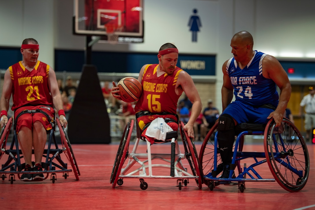 U.S. Marine Corps veteran Isaac Blunt fends off an Air Force defender at the DoD Warrior Games wheelchair basketball tournament in Tampa, Florida, June 24, 2019. The 2019 Warrior Games consist of 13 Paralympic-style sports, and more than 300 athletes representing the U.S. Marine Corps, Army, Navy, Air Force, Special Operations Command, and five international teams.