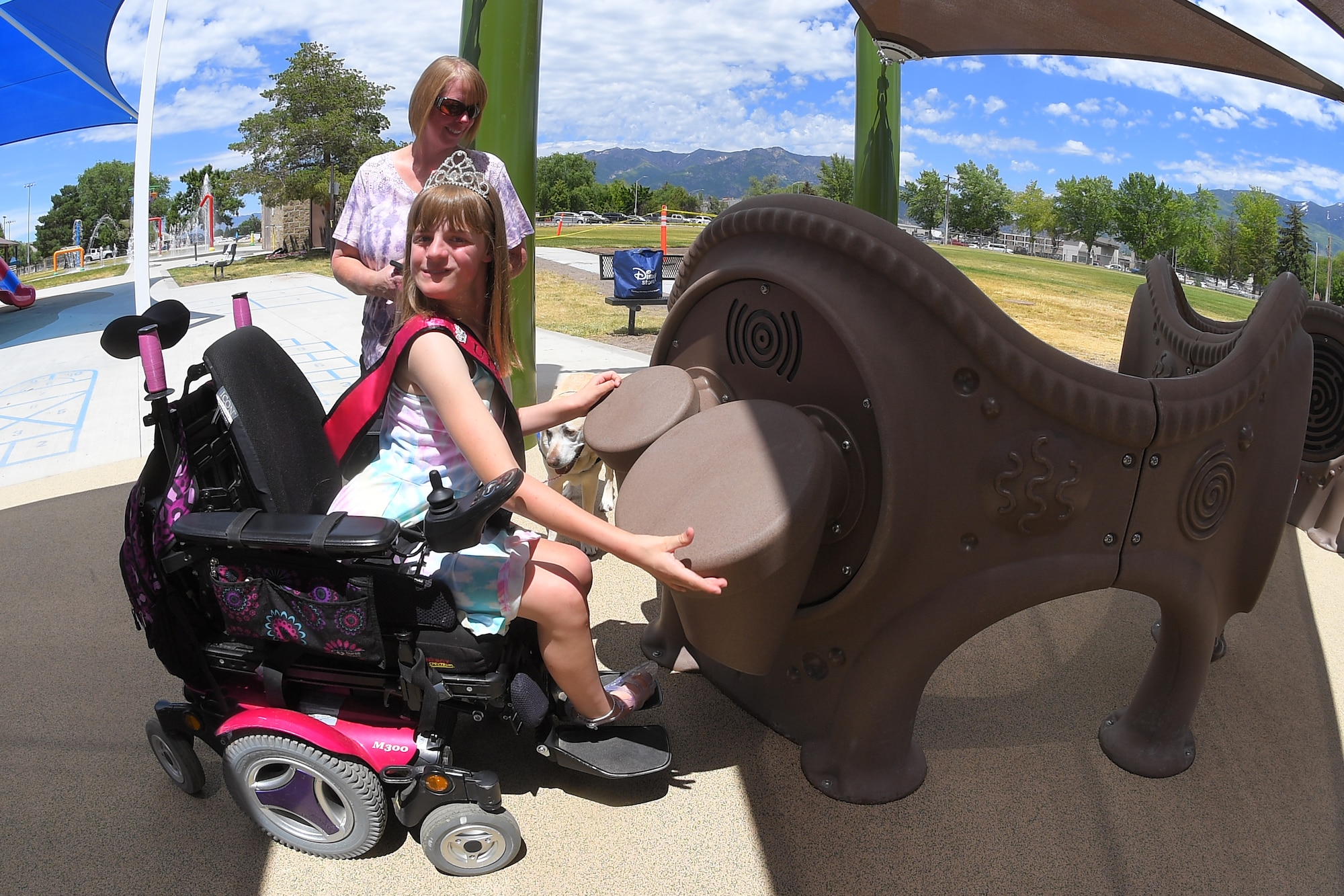 Brianna and her mother, Wendy Heim, enjoy the new, all-abilities playground at Centennial Park June 24, 2019, at Hill Air Force Base, Utah. The playground is wheelchair accessible and incorporates sensory areas with a mixture of music- and texture-focused equipment for children. (U.S. Air Force photo by Todd Cromar)