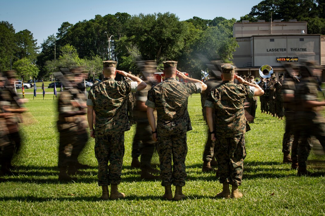 Lt. Col. Anthony A. Tilelli, right, relieves Lt. Col. Jeffrey S. Pelt, middle, during the Headquarters and Headquarters Squadron change of command ceremony aboard Marine Corps Air Station Beaufort, June 21. During the ceremony all previous commanders of H&HS were also invited to the reviewing area.