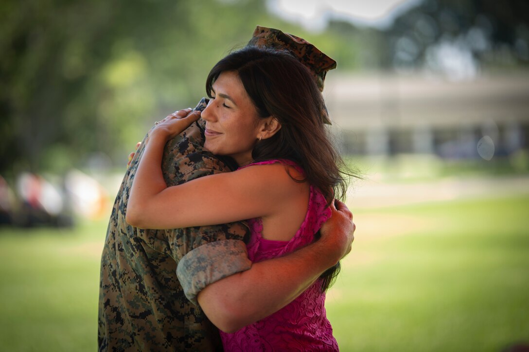 Lt. Col. Jeffery S. Pelt hugs his wife during the Headquarters and Headquarters Squadron change of command aboard Marine Corps Air Station Beaufort, June 21. During the ceremony Lt. Col. Anthony A. Tilelli relieve Pelt of command.