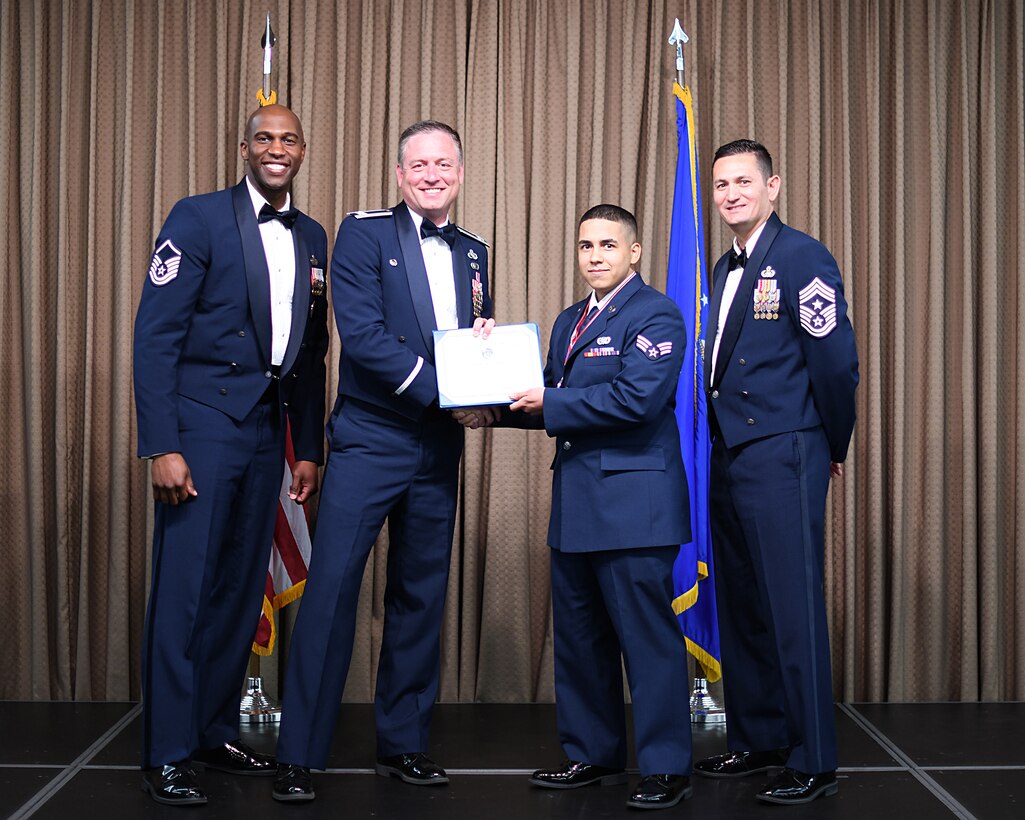 Col. Benjamin Spencer, 319th Air Base Wing commander, presents diploma to SrA Jose Feleciano, Etchberger Airman Leadership School graduate, June 20, 2019, on Grand Forks Air Force Base, North Dakota. ALS graduation is the culmination of the first level of the Enlisted Professional Military Education continuum directed toward preparing upcoming noncommissioned officers with leadership skills for their careers. (U.S. Air Force photo by Senior Airman Elijaih Tiggs)