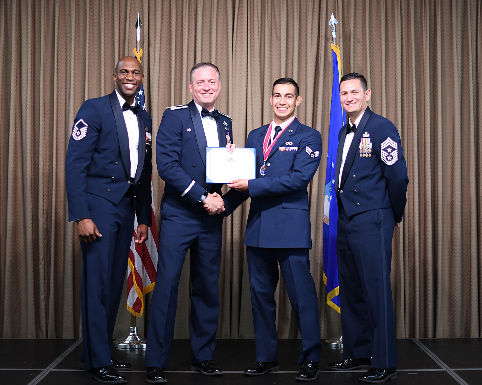 Col. Benjamin Spencer, 319th Air Base Wing commander, presents diploma to SrA Job Hernandez, Etchberger Airman Leadership School graduate, June 20, 2019, on Grand Forks Air Force Base, North Dakota. ALS graduation is the culmination of the first level of the Enlisted Professional Military Education continuum directed toward preparing upcoming noncommissioned officers with leadership skills for their careers. (U.S. Air Force photo by Senior Airman Elijaih Tiggs)