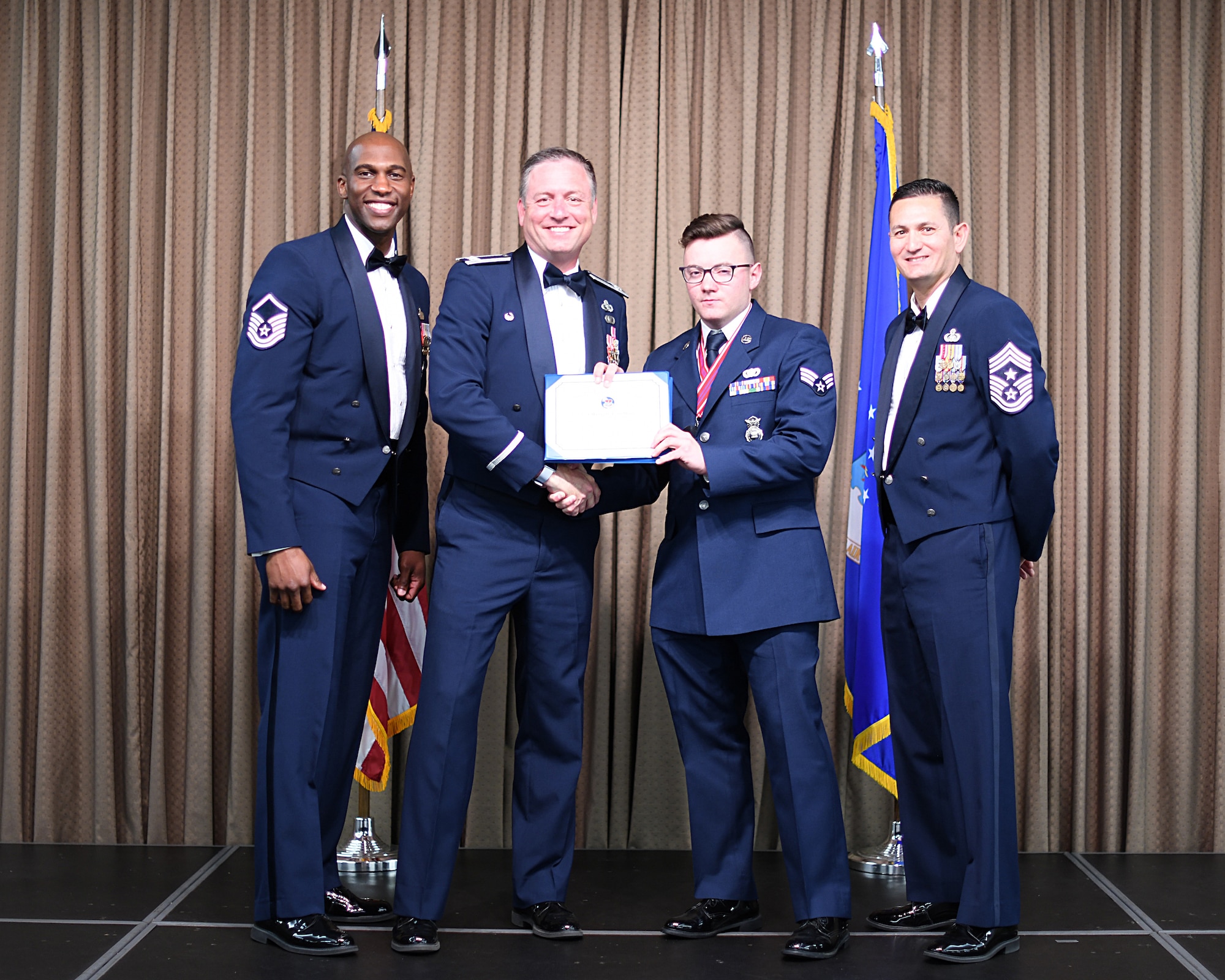 Col. Benjamin Spencer, 319th Air Base Wing commander, presents diploma to SrA Maxwell Stebbins, Etchberger Airman Leadership School graduate, June 20, 2019, on Grand Forks Air Force Base, North Dakota. ALS graduation is the culmination of the first level of the Enlisted Professional Military Education continuum directed toward preparing upcoming noncommissioned officers with leadership skills for their careers. (U.S. Air Force photo by Senior Airman Elijaih Tiggs)