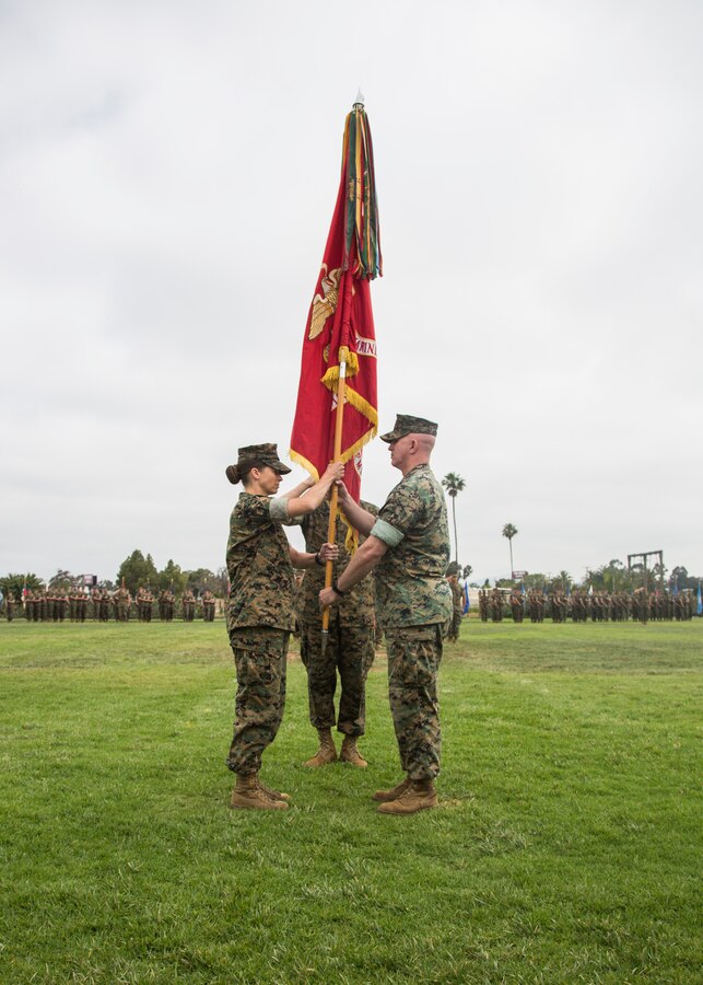 U.S. Marine Corps Lt. Col. Richard C. Martin, right, outgoing commanding officer of Marine Aviation Logistics Squadron (MALS) 16, Marine Aircraft Group (MAG) 16, 3rd Marine Aircraft Wing (MAW), passes the colors during MALS-16's change of command ceremony on Marine Corps Air Station Miramar, Calif., June 19, 2019. During the ceremony, Martin was recognized for his leadership, service and dedication to the Corps. The unit also welcomed Lt. Col. Meghan A. Kennerly as the new commanding officer. (U.S. Marine Corps photo by Cpl. Samuel Ruiz)