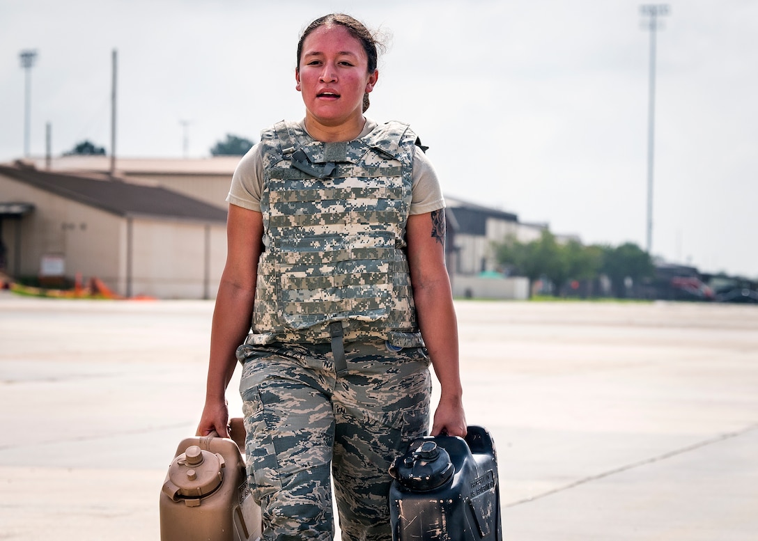 Airman Breanna Breceda, 23d Logistics Readiness Squadron (LRS) fuels distribution operator, carries water jugs during the Forward Area Refueling Point (FARP) team tryouts, June 21, 2019, at Moody Air Force Base, Ga. Eleven Airmen from the 23d LRS Petroleum, Oils and Lubricants flight were judged and evaluated on their ability to carry various fueling equipment to and from checkpoints as quickly as possible. The FARP team’s mission requires for them to carry heavy fueling equipment to and from aircraft in a quick manner; so the tryouts were designed to gauge Airmen’s physical readiness to complete their mission. Following the tryouts, the Airmen were interviewed to further evaluate their mental readiness to join the FARP team and ultimately one Airman will be chosen. (U.S. Air Force photo by Airman 1st Class Eugene Oliver)