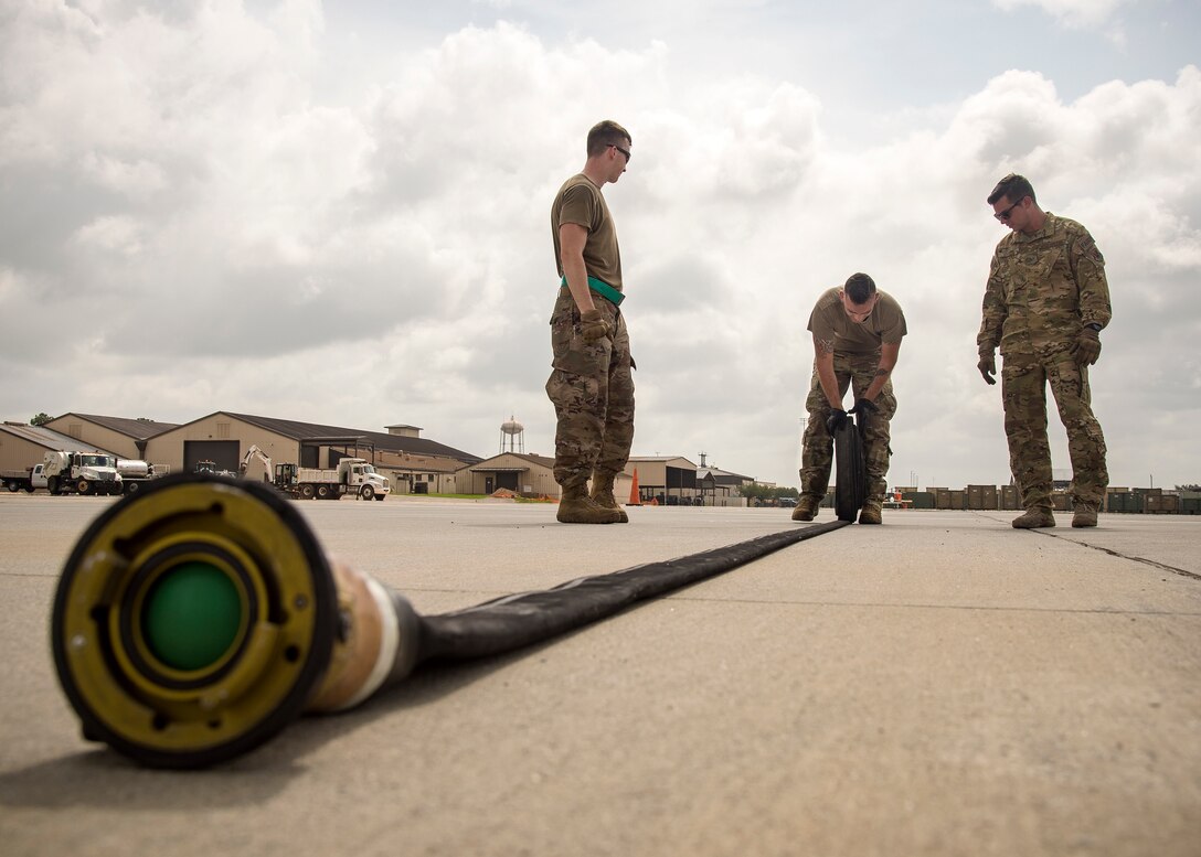 An Airman from the 23d Logistics Readiness Squadron (LRS), rolls up a fuel line hose during the Forward Area Refueling Point (FARP) team tryouts, June 21, 2019, at Moody Air Force Base, Ga. Eleven Airmen from the 23d LRS Petroleum, Oils and Lubricants flight were judged and evaluated on their ability to carry various fueling equipment to and from checkpoints as quickly as possible. The FARP team’s mission requires for them to carry heavy fueling equipment to and from aircraft in a quick manner, so the tryouts were designed to gauge Airmen’s physical readiness to complete their mission. Following the tryouts the Airmen were interviewed to further evaluate their mental readiness to join the FARP team and ultimately one Airman will be chosen. (U.S. Air Force photo by Airman 1st Class Eugene Oliver)