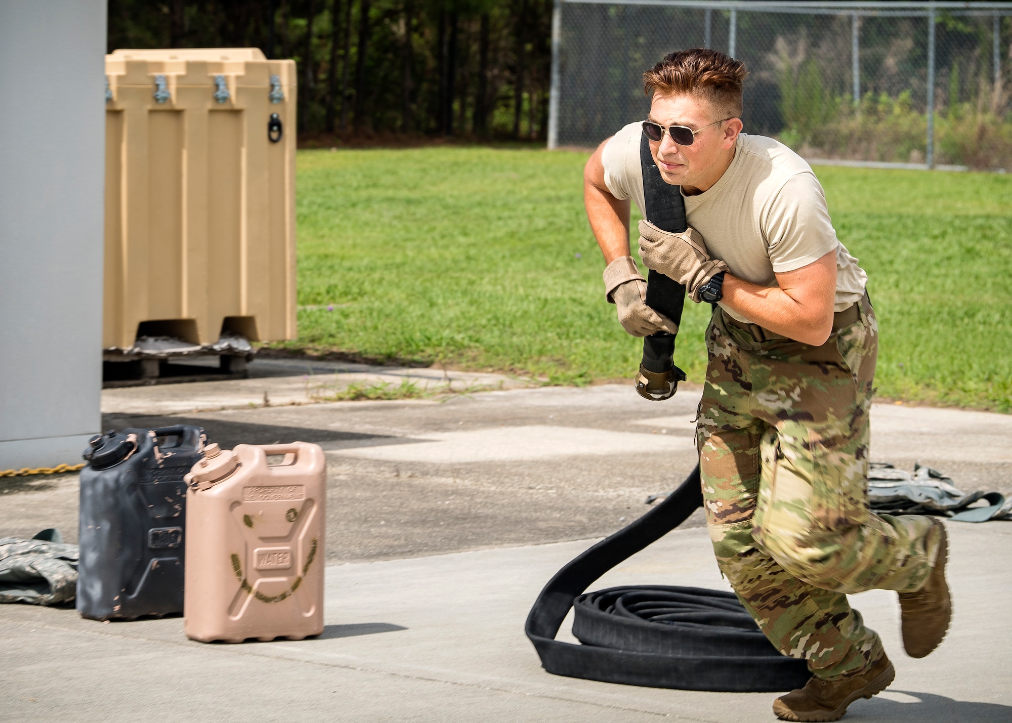 Senior Airman Sam Neas, 71st Rescue Squadron loadmaster, carries a fuel line hose during Forward Area Refueling Point (FARP) tryouts, June 21, 2019, at Moody Air Force Base, Ga. Neas participated to better understand the 23d Logistics Readiness Squadron’s FARP team of elite fuels special operators whose mission is to provide needed fuel to aircraft in any environment in a swift manner. This greatly extends the reach of the personnel recovery mission by increasing options and ensuring safety for the rescue community. (U.S. Air Force photo by Airman 1st Class Eugene Oliver)