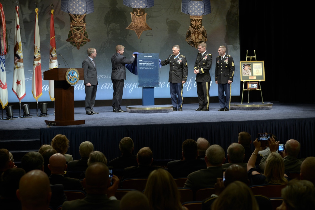 A man is recognized at a ceremony.