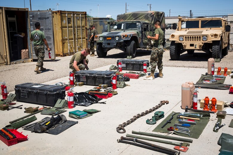 U.S. Marine Corps Motor Vehicle Operators assigned to Marine Unmanned Aerial Squadron (VMU) 1 gather issued gear together for placement in the 7-ton Medium Tactical Vehicle Replacement (MTVRs) and Humvee vehicles at Marine Corps Air Station Yuma, Ariz., June 18, 2019. The gear included basic vehicle repair items, tools, and first-aid items for the operators to use in case of emergency or mishap. (U.S. Marine Corps photo by Sgt. Isaac D. Martinez)