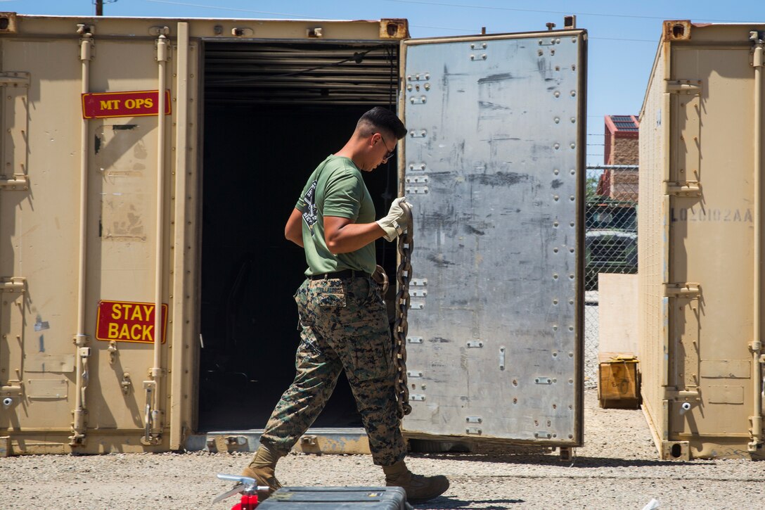 U.S. Marine Corps Motor Vehicle Operators assigned to Marine Unmanned Aerial Squadron (VMU) 1 gather issued gear together for placement in the 7-ton Medium Tactical Vehicle Replacement (MTVRs) and Humvee vehicles at Marine Corps Air Station Yuma, Ariz., June 18, 2019. The gear included basic vehicle repair items, tools, and first-aid items for the operators to use in case of emergency or mishap. (U.S. Marine Corps photo by Sgt. Isaac D. Martinez)