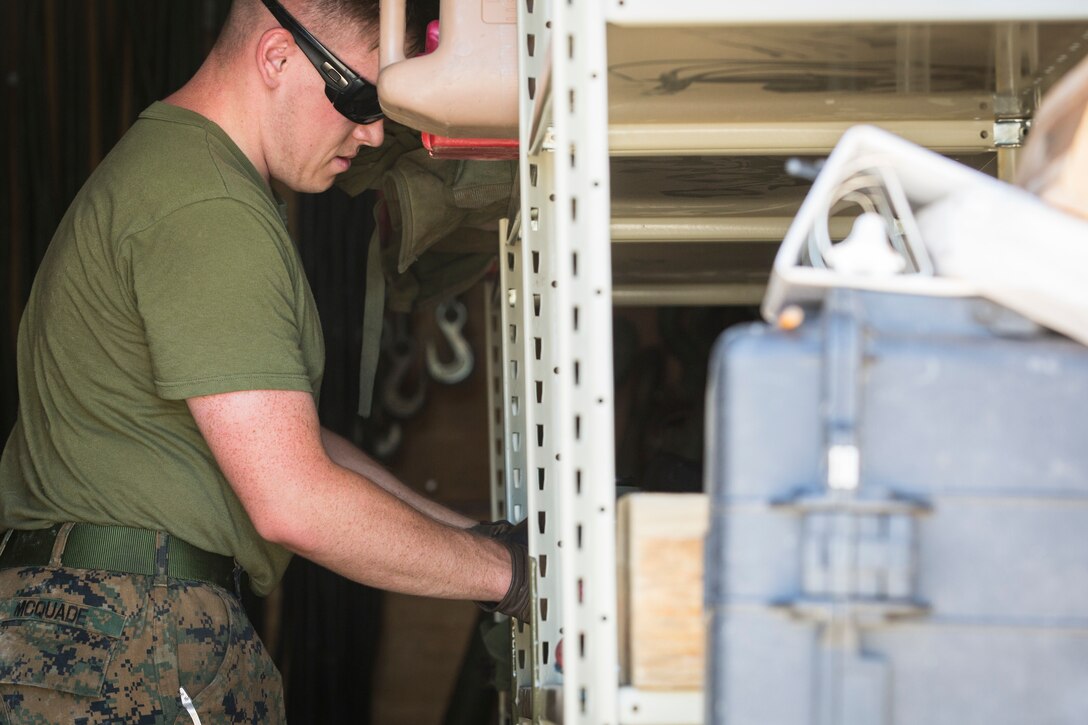 U.S. Marine Corps Motor Vehicle Operators assigned to Marine Unmanned Aerial Squadron (VMU) 1 gather issued gear together for placement in the 7-ton Medium Tactical Vehicle Replacement (MTVRs) and Humvee vehicles at Marine Corps Air Station Yuma, Ariz., June 18, 2019. The gear included basic vehicle repair items, tools, and first-aid items for the operators to use in case of emergency or mishap. (U.S. Marine Corps photo by Sgt. Isaac D. Martinez)