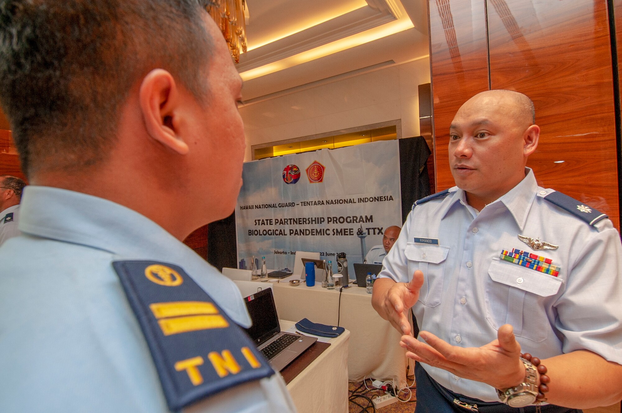 Lt. Col. Marlon Rimando, 154th Medical Group Detachment 1 physician and force health protection team chief discusses the importance of force health protection with a member of the Indonesian Armed Forces during a Pandemic Subject Matter Expert Exchange held in Jakarta, Indonesia on Jun 19, 2019.