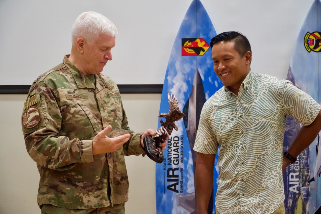 Lt. Gen. L. Scott Rice, Director of the Air National Guard, prepares to present Airman 1st Class Noel Tadeo 169th Air Defense Group command and control battle management operator, with the C2 Battle Management Operations Airmen of the year award on June 21, 2019 at Joint Base Pearl Harbor-Hickam.