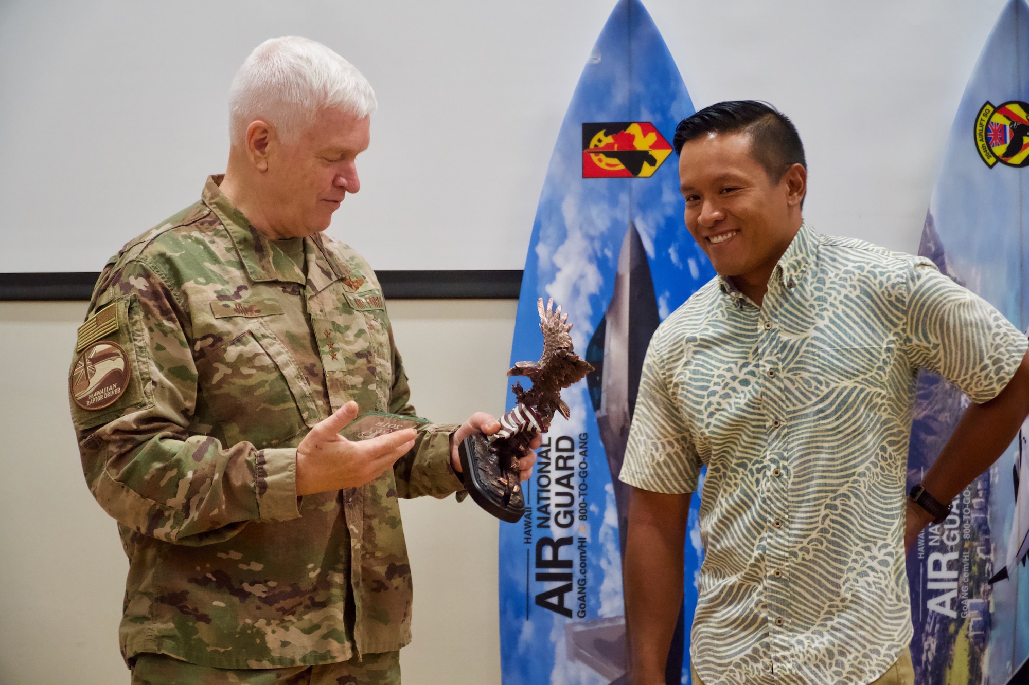 Lt. Gen. L. Scott Rice, Director of the Air National Guard, prepares to present Airman 1st Class Noel Tadeo 169th Air Defense Group command and control battle management operator, with the C2 Battle Management Operations Airmen of the year award on June 21, 2019 at Joint Base Pearl Harbor-Hickam.