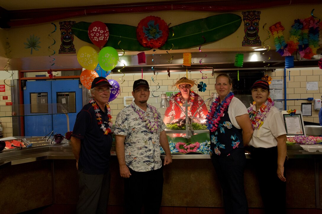 U.S. Marines stationed at Marine Corps Air Station (MCAS) Yuma are served a Traditional Pig Roast at the mess hall on MCAS Yuma Ariz., June 19, 2019. The roasted pig is part of MCAS Yuma’s annual Hawaiian Luau Meal, which is intended to raise the spirits and fill the bellies of the Marines and Sailors stationed at MCAS Yuma. (U.S. Marine Corps photo by Cpl. Joel Soriano)