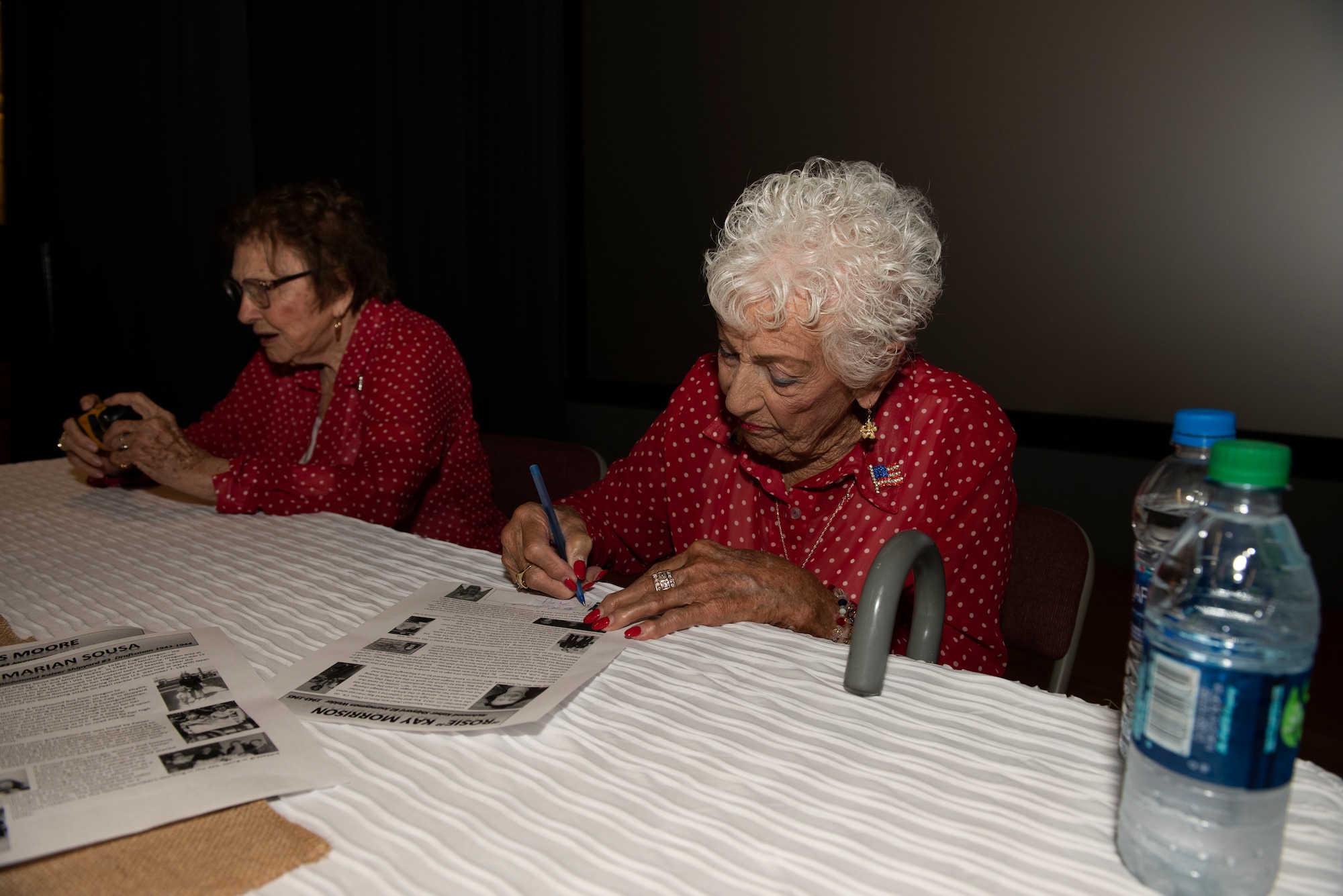 Kay Morrison, 95, signs a print out of her biography June 25, 2019, at Travis Air Force Base, California. Morrison is one of the many women known as ‘Rosie the Riveter’ as she worked as a welder in the Richmond, California, Kaiser Shipyard from 1943 – 1945. During a visit to Travis AFB, she and three other Rosies met with 60th Air Mobility Wing leadership, had lunch with Airmen and shared their experiences. (U.S. Air Force photo by Tech. Sgt. James Hodgman)