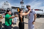 KOTA KINABALU, Malaysia (June 26, 2019) Lt. Cmdr. Robert Wayland, commanding officer of the Avenger-class mine countermeasures ship USS Pioneer (MCM 9), is greeted by locals after pulling into Kota Kinabalu, Malaysia. Pioneer, part of Mine Countermeasures Squadron 7, is operating in the 7th Fleet area of operations to enhance interoperability with partners and serve as a ready-response platform for contingency operations.
