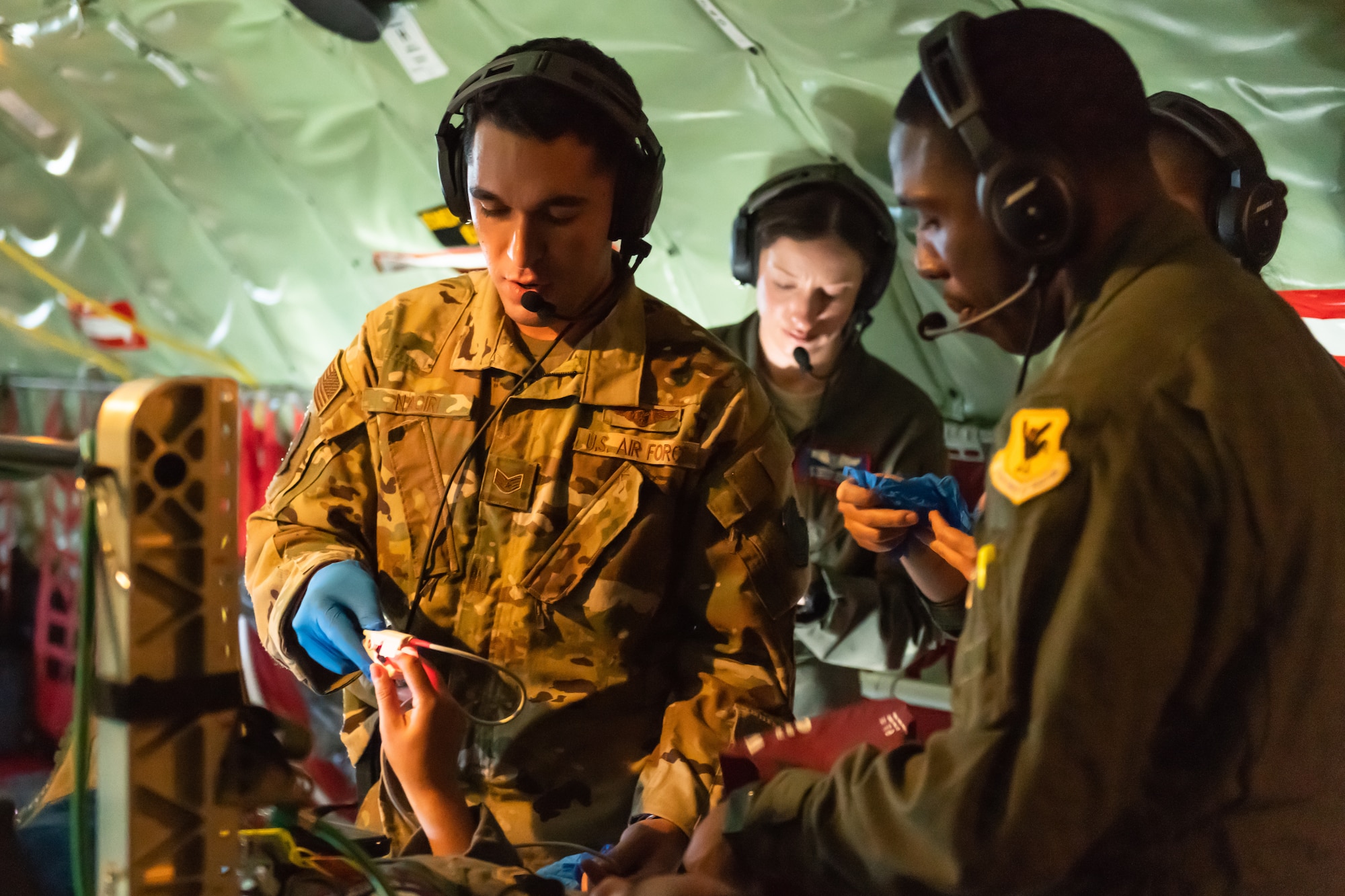 Airmen from the 18th Aeromedical Evacuation Squadron triage a patient onboard a KC-135 Stratotanker during an exercise May 8th, 2019, out of Kadena Air Base, Japan. The 18th AES maintains a forward operating presence and supports medical contingencies in a free-and-open Indo-Pacific. (U.S. Air Force photo by Airman 1st Class Matthew Seefeldt)