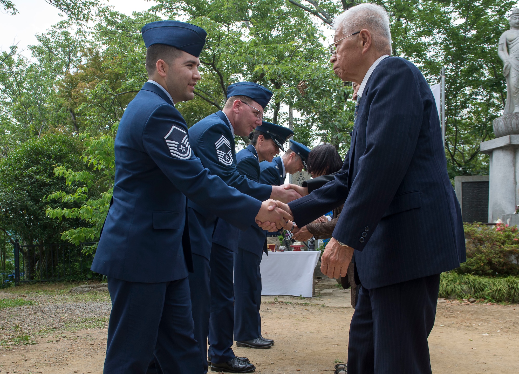 Members of the 374th Airlift Wing, Yokota Air Base, Japan, shake hands with surviving family members of the Japanese Imperial Army during the 47th annual B-29 Memorial Ceremony at Sengen Shrine in Shizuoka City, Japan, June 22, 2019.