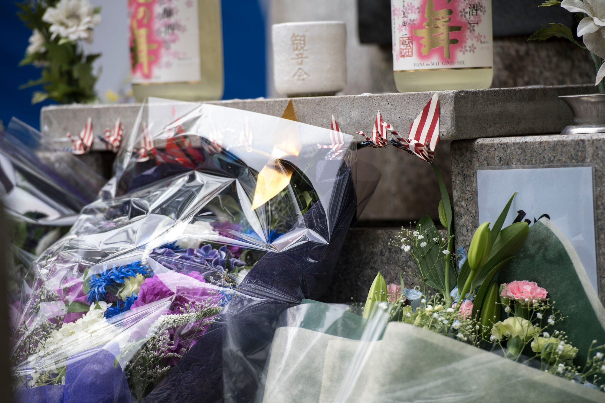 Flowers and Sake rest at the base of the Japanese B-29 memorial monument at Sengen Shrine in Shizuoka City, Japan, June 22, 2019.