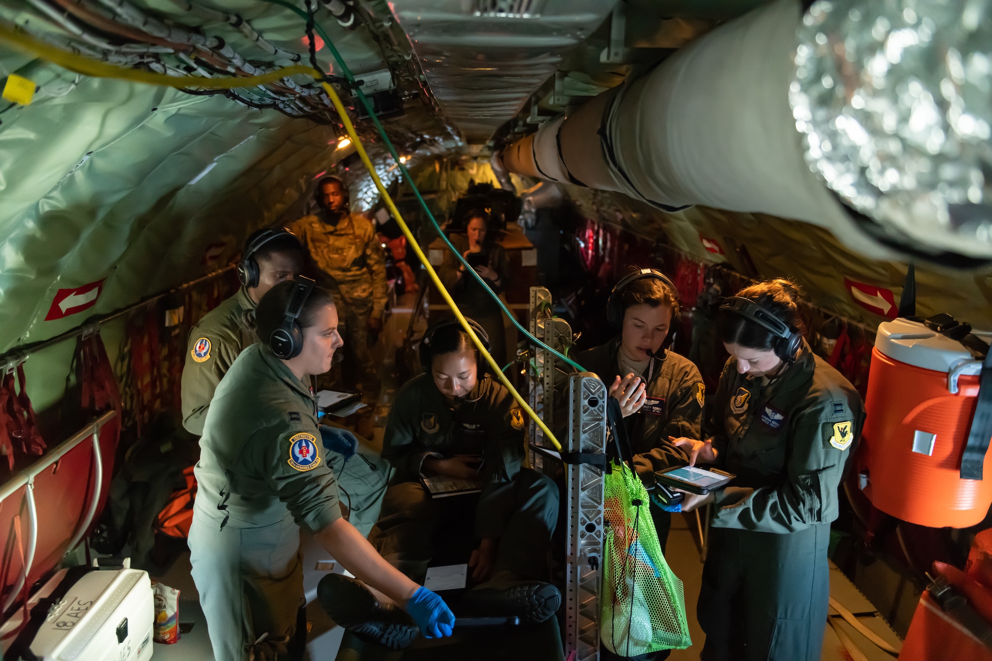 Airmen from the 18th Aeromedical Evacuation Squadron triage a patient onboard a KC-135 Stratotanker during an exercise May 8th, 2019, out of Kadena Air Base, Japan. The 18th AES maintains a forward operating presence and supports medical contingencies in a free-and-open Indo-Pacific. (U.S. Air Force photo by Airman 1st Class Matthew Seefeldt)
