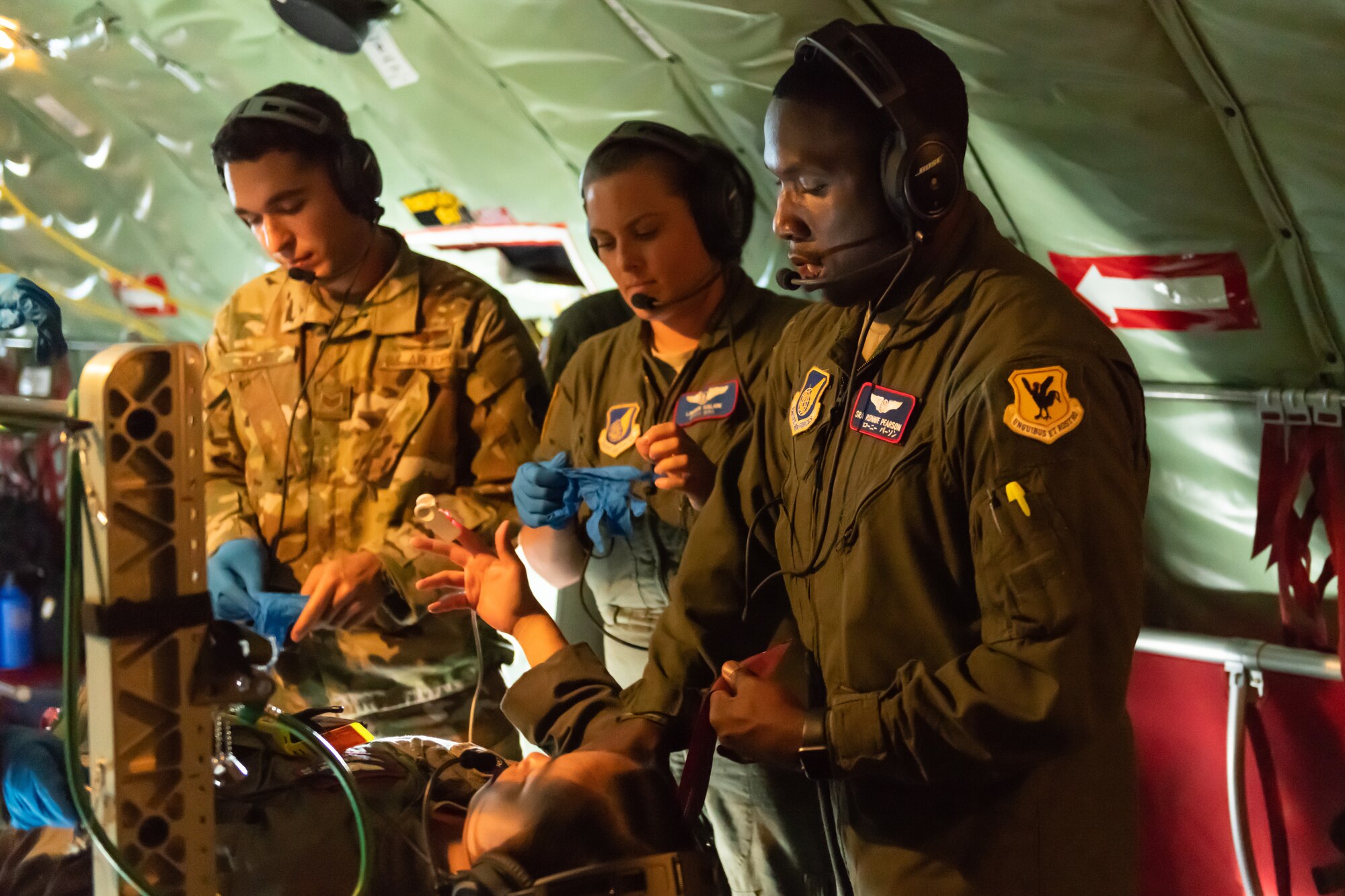 Airmen from the 18th Aeromedical Evacuation Squadron triage a patient onboard a KC-135 Stratotanker during an exercise May 8th, 2019, out of Kadena Air Base, Japan. The 18th AES deploys and operates elements of a theatre aeromedical evacuation system capable of worldwide taskings. (U.S. Air Force photo by Airman 1st Class Matthew Seefeldt)