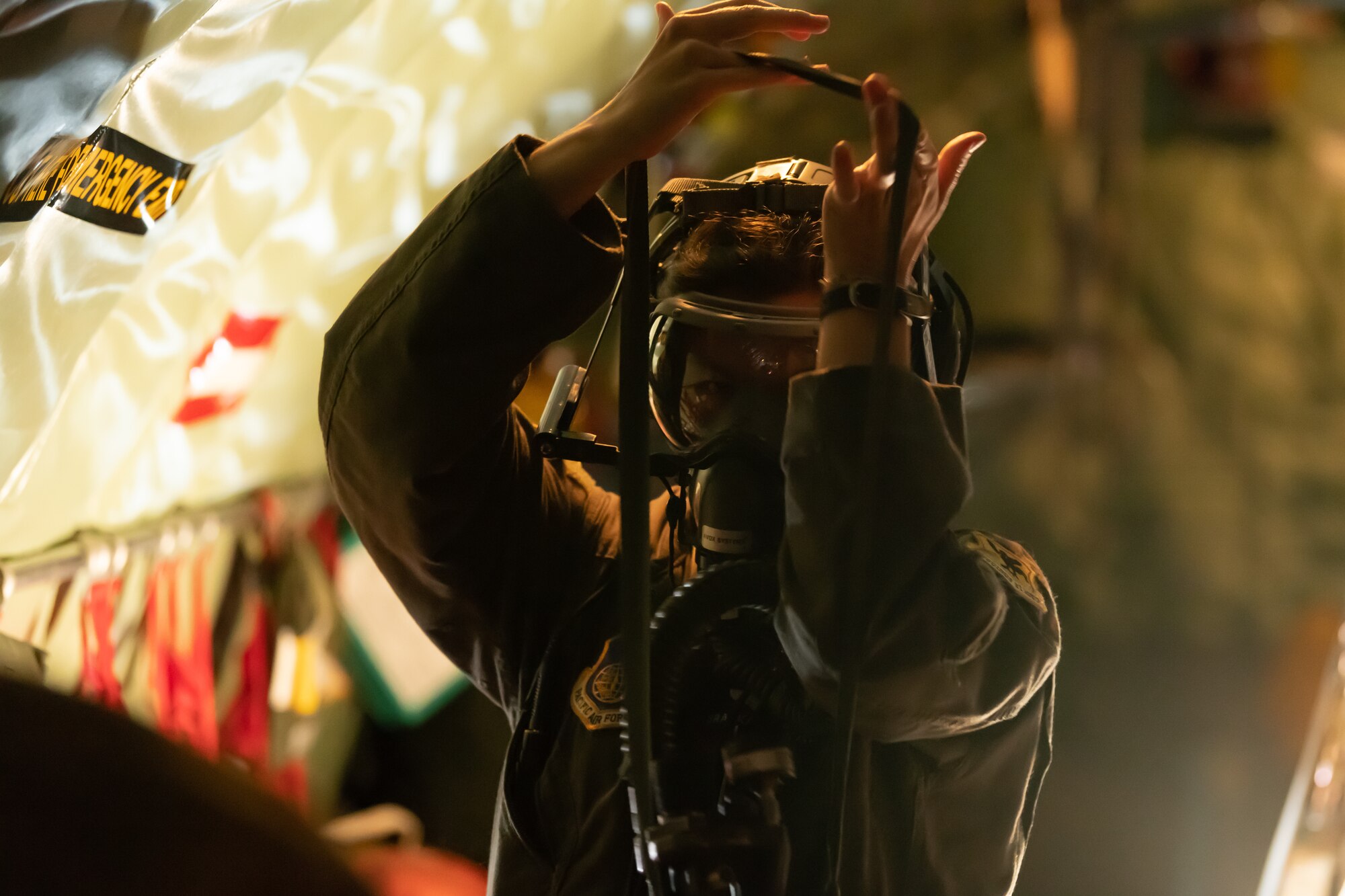 U.S. Air Force Senior Airman Kasey Bober, 18th Aeromedical Evacuation Squadron technician puts on her oxygen mask during an emergency depressurization drill onboard a KC-135 Stratotanker, May 8th, 2019, out of Kadena Air Base, Japan. The 18th AES maintains a forward operating presence and supports medical contingencies in a free-and-open Indo-Pacific. (U.S. Air Force photo by Airman 1st Class Matthew Seefeldt)