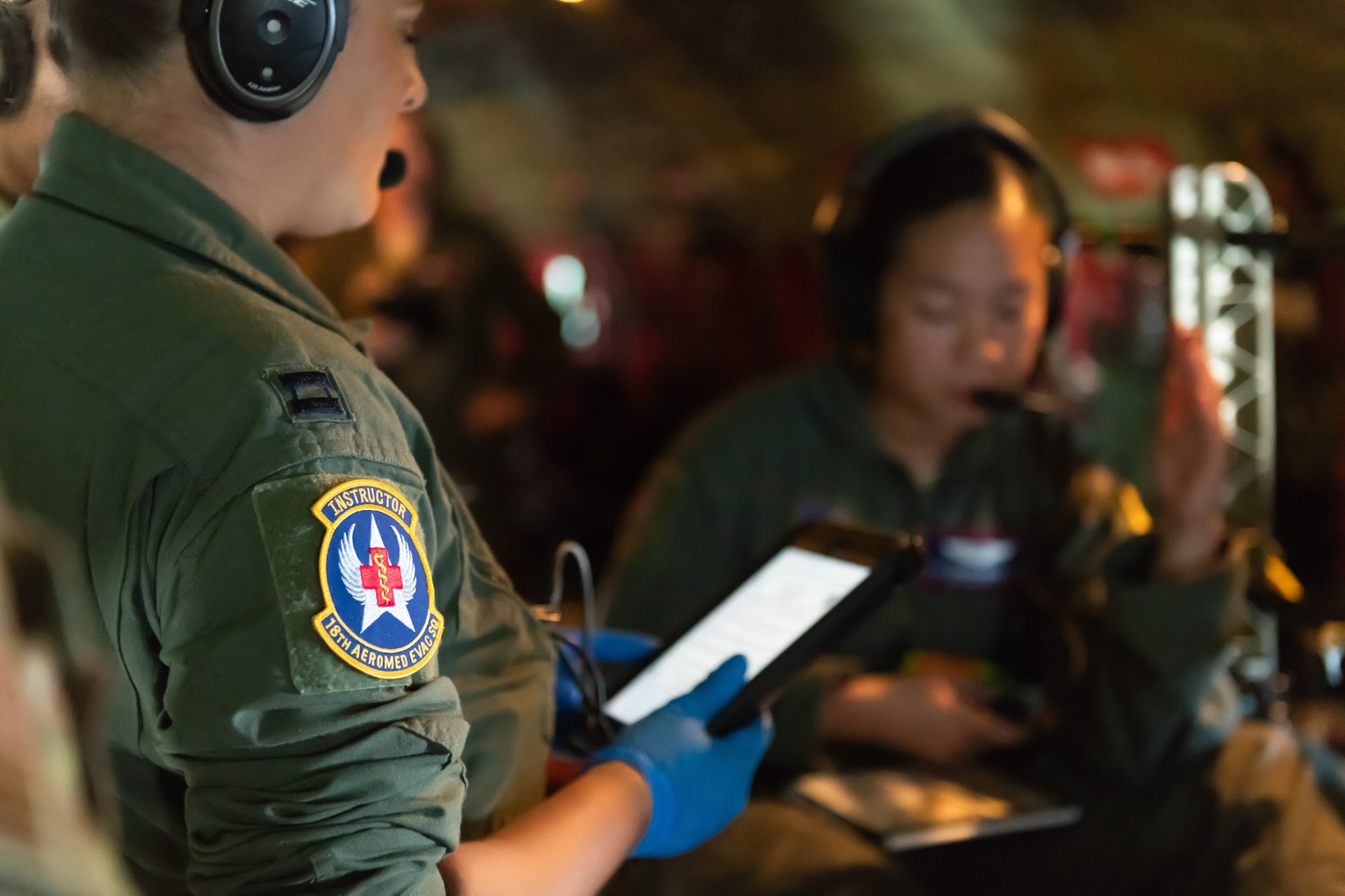 U.S. Air Force Capt. Lauren Kalani, 18th Aeromedical Evacuation Squadron flight nurse looks over her electronic flight book onboard a KC-135 Stratotanker during an exercise May 8th, 2019, out of Kadena Air Base, Japan. The 18th AES deploys and operates elements of a theatre aeromedical evacuation system capable of worldwide taskings. (U.S. Air Force photo by Airman 1st Class Matthew Seefeldt)