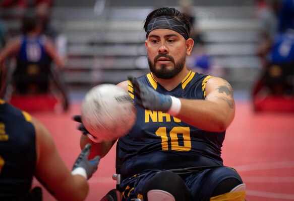 Emmanuel Gonzalez, a Team Navy Wounded Warrior, passes the ball during the 2019 DoD Warrior Games wheelchair rugby game.