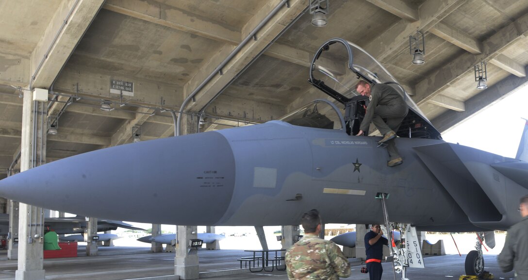 U.S. Air Force Brig. Gen. Case Cunningham, 18th Wing commander, climbs out of the cockpit of an F-15 Eagle after his final or fini flight as wing commander at Kadena Air Base, Japan, June 27, 2019.