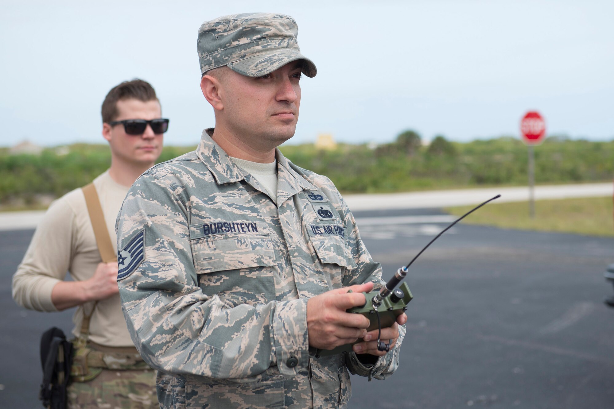 Tech. Sgt. Dmitriy Burshteyn, a field test team noncommissioned officer in charge with the Air Force Technical Applications Center, uses a remote firing device to detonate explosives while field testing new infrasound equipment at Cape Canaveral Air Force Station, Fla.  (U.S. Air Force photo by Matthew S. Jurgens)