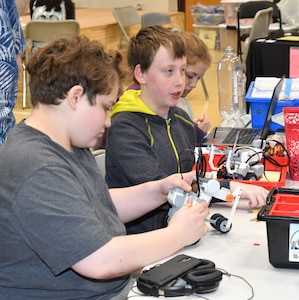 IMAGE: KING GEORGE. Va. (June 26, 2019) - Middle school students build a robot at the 2019 Naval Surface Warfare Center Dahlgren Division (NSWCDD)-sponsored Navy science, technology, engineering, and mathematics (STEM) Summer Academy, held June 24-28. They are among 70 middle school students who are developing their teamwork and problem-solving skills in math and science while partnering with a teacher and an NSWCDD scientist or engineer. The STEM Summer ‘campers’ will deploy the robots they design, build, and program to respond to 10 missions - including the delivery of humanitarian aid, rotating troops and transporting an electromagnetic railgun to the deck of a Navy ship – by the end of the week-long academy.