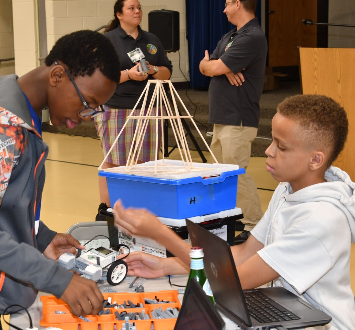 IMAGE: KING GEORGE. Va. (June 26, 2019) - Middle school students build a robot at the 2019 Naval Surface Warfare Center Dahlgren Division (NSWCDD)-sponsored Navy science, technology, engineering, and mathematics (STEM) Summer Academy, held June 24-28. They are among 70 middle school students who are developing their teamwork and problem-solving skills in math and science while partnering with a teacher and an NSWCDD scientist or engineer. The STEM Summer ‘campers’ will deploy the robots they design, build, and program to respond to 10 missions - including the delivery of humanitarian aid, rotating troops and transporting an electromagnetic railgun to the deck of a Navy ship – by the end of the week-long academy.